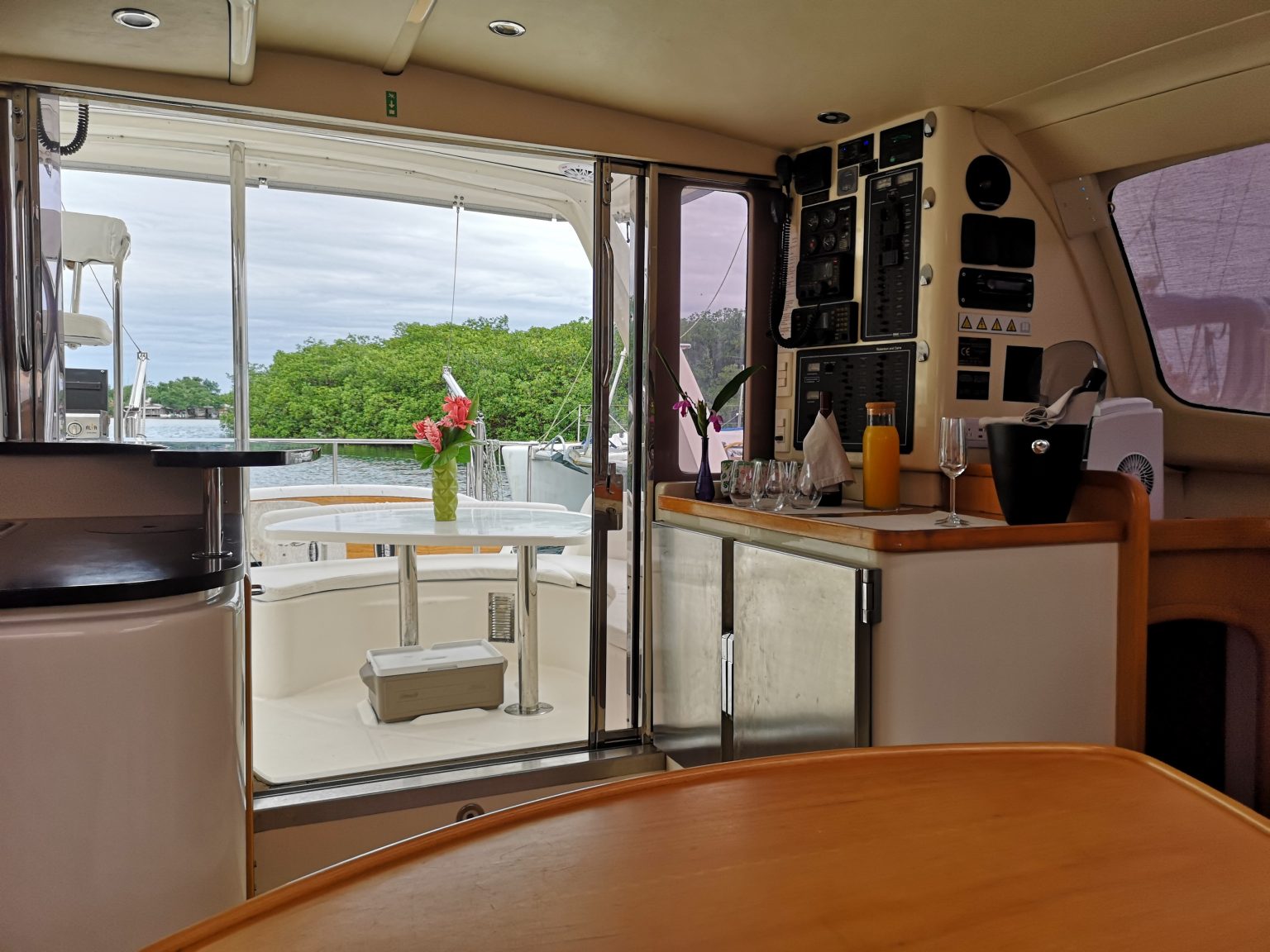 Aventura's cockpit bar, styled with fresh flowers, anchored off a mangrove shoreline