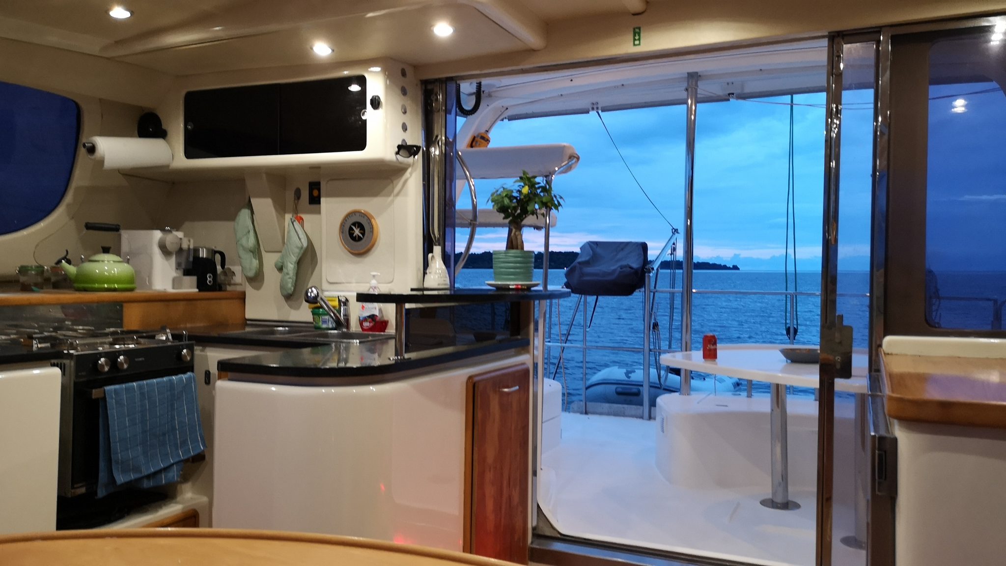 Aventura's galley opening onto the aft deck at dusk