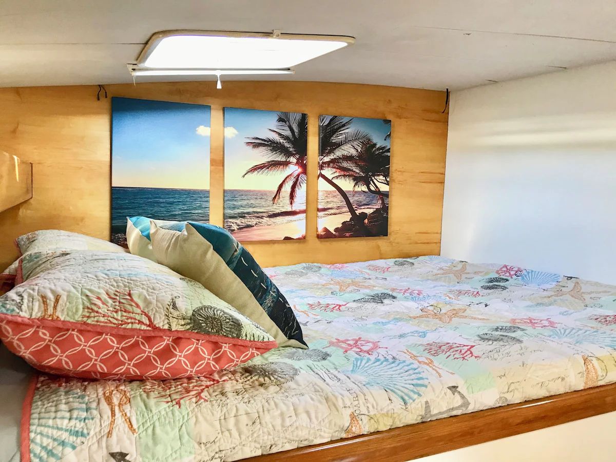 One of Exta Sea's guest cabins, with a beach-themed triptych above the berth